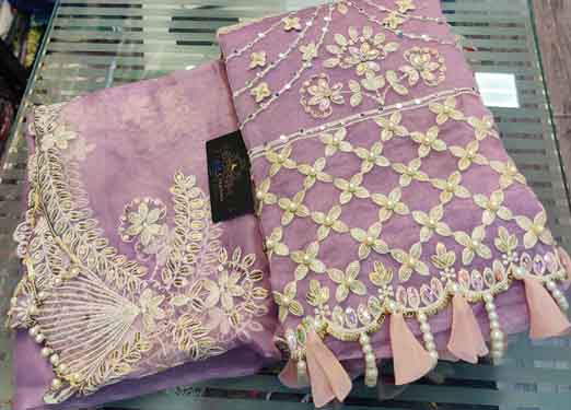 Organza with beautiful embroidery & sequins butti daman and sleeves used to enhance